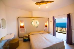 a bedroom with a bed and a view of the ocean at Hotel Saraceno in Giglio Porto