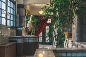 a large bird standing in a room with plants at Marufukuro in Kyoto
