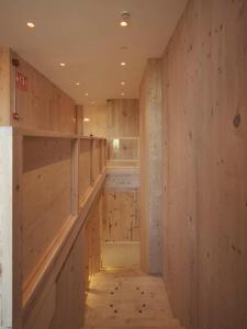 a room with wooden walls and a hallway with wooden floors at Hotel Amiuka in O Pedrouzo