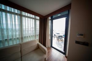 a living room with a couch and a large window at Golden Royal Hotel & SPA in Istanbul