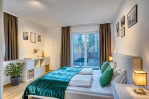 a bedroom with a large bed and a window at NA-Home Kitzbühel Tristkogel in Kitzbühel