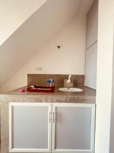 a bathroom with a sink and a white cabinet at Devo's place in Galle