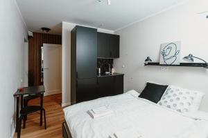 a bedroom with a bed and a desk in it at Cosy Central Studio Apt. - Near Old Town in Riga