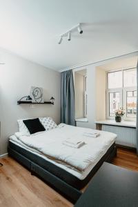 a bedroom with a large bed and two windows at Cosy Central Studio Apt. - Near Old Town in Riga