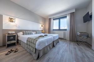 Voodi või voodid majutusasutuse Apartamentos Caribou toas +19 fotot