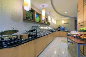 a large kitchen with a buffet line in a restaurant at SpringHill Suites Devens Common Center in Devens