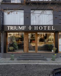 a trump hotel sign in front of a building at Triumf Hotel in Prizren
