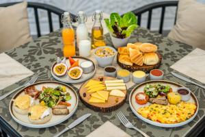 a table topped with plates of food on a table at The Wander by Sarai in Siem Reap