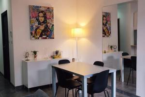 a dining room with a white table and chairs at Chalet cosy en centre-ville in Le Puy-en-Velay