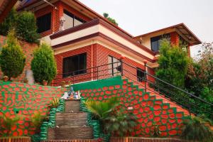 a house with a staircase in front of it at Doleshwor Village Resort and Farm House Pvt Ltd in Bhaktapur