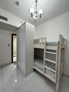 a room with bunk beds and a chandelier at Homecation in Dubai