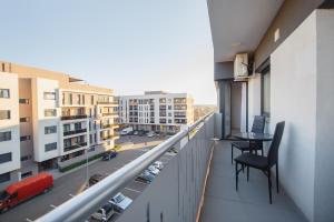 a balcony with a table and a view of a city at Pinky Black Escape in Oradea