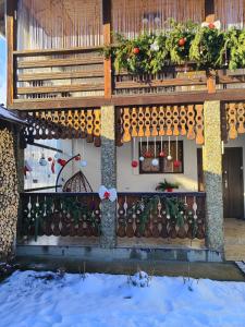 a house with a balcony with flowers on it at Карпатський куточок in Slavske