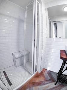 a shower with a glass door in a bathroom at Tóni Villa in Budapest