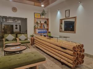 a living room with a wooden bench and tables at Hotel Dralha in Thimphu