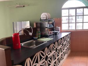 a kitchen with a sink and a counter top at Amy Home Moonlight APARTMENT in Brinchang