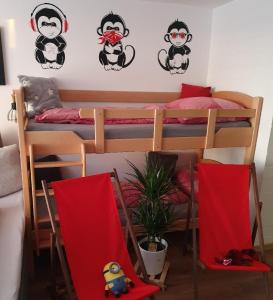 a room with two bunk beds with red flags at Ferienwohnung Winklworld 2 mit Hallenbad und Sauna inklusive aktivCARD in Sankt Englmar