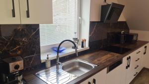 a kitchen counter with a sink and a window at Apartmán Malá Valaška in Ratiboř +44 photos