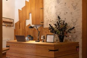 a desk with a laptop and a lamp on it at Hotel Lipa in Kranjska Gora