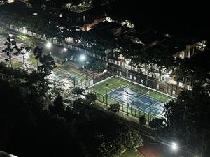 a tennis court in a city at night at Royal Nest 4 BHK in Pune