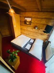 a bedroom with a bed in a wooden room at Bukovina Concept Mountain in Bukowina Tatrzańska