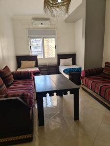 a living room with couches and a coffee table at Namaste Lodge in Tamraght Ouzdar