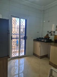 a kitchen with a door open to a patio at Namaste Lodge in Tamraght Ouzdar