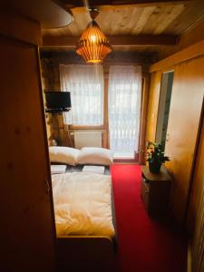 a bedroom with two beds and a chandelier at Bukovina Concept Mountain in Bukowina Tatrzańska