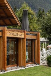 a restaurant building with a sign in front of it at Hotel Lipa in Kranjska Gora