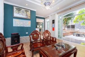 a living room with a dining room table and chairs at Villa BLUE DAY VIEW Biển TRẦN PHÚ Siêu Đẹp in Vung Tau