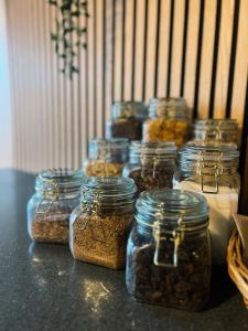 a group of jars filled with nuts on a table at KonceptHotel in Oksbøl