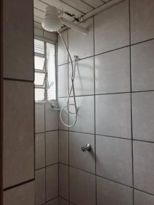 een douche met een douchekop in de badkamer bij RECANTO DA IZAURINHA in Olímpia