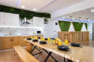 uma cozinha com uma mesa de madeira com copos de sumo de laranja em Lightbooking Villa Arali - Lujo renovado en Tenerife em Fasnia