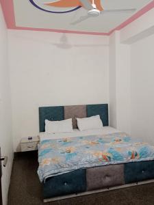 a bedroom with a bed with a colorful bedspread at STAR HOTEL in Bahādurgarh