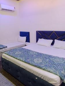 a bedroom with two beds in a room at STAR HOTEL in Bahādurgarh