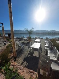 a group of tables and chairs sitting next to the water at VENETO VILLAGE MR in Villa Parque Siquiman