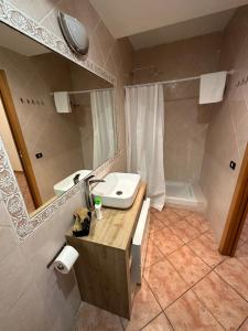ein Badezimmer mit einem Waschbecken, einem Spiegel und einer Badewanne in der Unterkunft Residence Villa il sogno in Rom