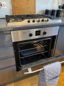 an oven with its door open in a kitchen at Luxury 2 Bedroom Aparmant in Morley in Morley
