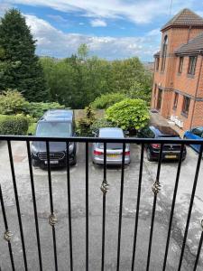 a balcony with two cars parked in a parking lot at Luxury 2 Bedroom Aparmant in Morley in Morley