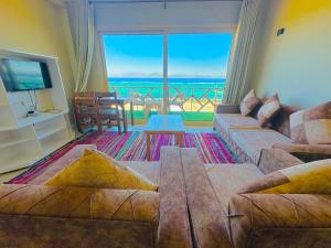 a living room with a couch and a large window at Moon house n.30 in Dahab