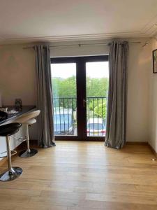 a room with a desk and a balcony with a view at Luxury 2 Bedroom Aparmant in Morley in Morley