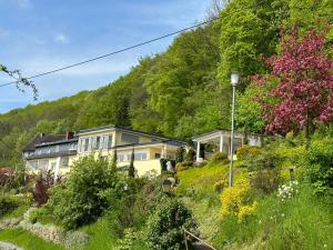 a house on the side of a hill at Villa Schaumburg - Boutique Hotel in Rinteln