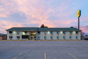 an empty parking lot in front of a building at Super 8 by Wyndham Livingston in Livingston