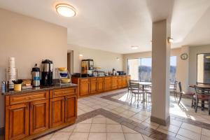 a large kitchen with wooden cabinets and a table at Days Inn by Wyndham Mooresville Lake Norman in Mooresville
