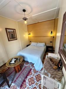 a hotel room with a bed and a table at Les IRIS in Al Hoceïma