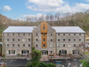 an image of a large brick building at Rock Mill Apt 3 with Terrace in Stony Middleton