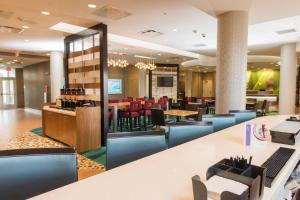 a lobby of a restaurant with tables and chairs at SpringHill Suites by Marriott Buffalo Airport in Williamsville