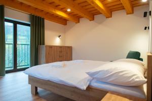 a bedroom with a large bed with white pillows at Villa Seraf in Terchová