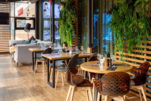 a row of tables and chairs in a restaurant at Radisson Blu Hotel Kaliningrad in Kaliningrad