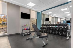 a fitness room with a row of gym equipment at Hampton Inn & Suites by Hilton Toronto Downtown in Toronto